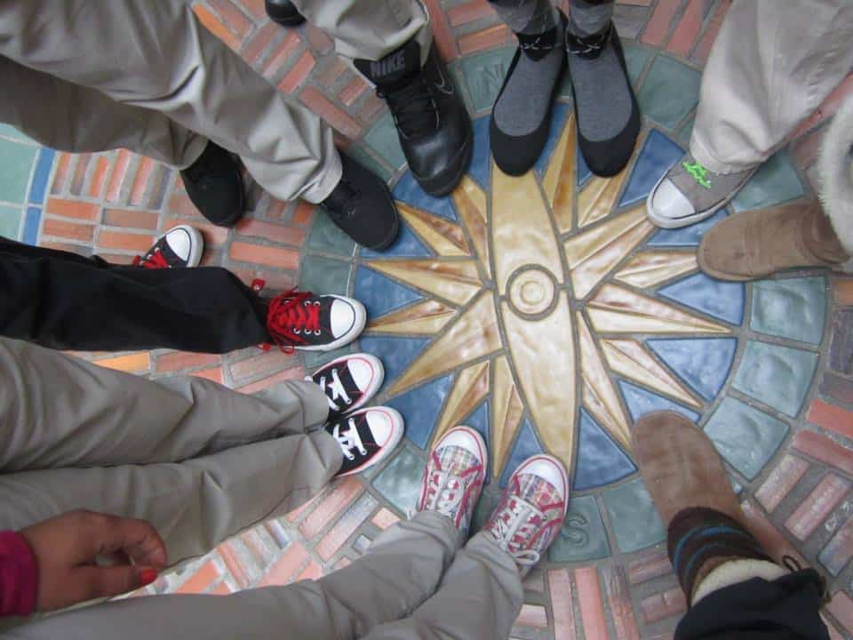 students standing in circle around star